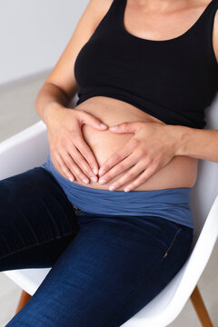 Young pregnant woman sitting on chair
