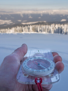 Germany, Upper Bavarian Forest Nature Park, man's hand holding compass in winter