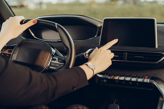 Young woman using navigation device in car