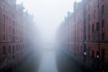 Germany, Hamburg, Speicherstadt, Old warehouses and canal in fog