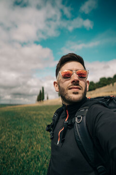 Portrait of young hiker with red mirrored glasses