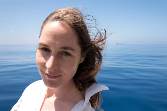 Seychelles, Indian Ocean, portrait of smiling woman on ferry