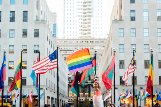 Hand waving LGBT flag in NYC, USA