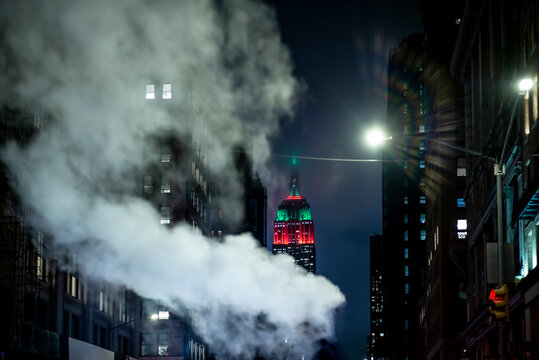 USA, New York, New York City, Smoke floating against illuminatedÔøΩEmpire State BuildingÔøΩat night