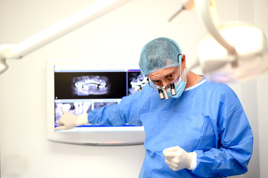 Dentist surgeon showing patient implant radiography