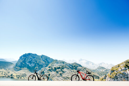 Two all terrain bicycles next to the mountains in Lagos de Covadonga, Asturias, Spain