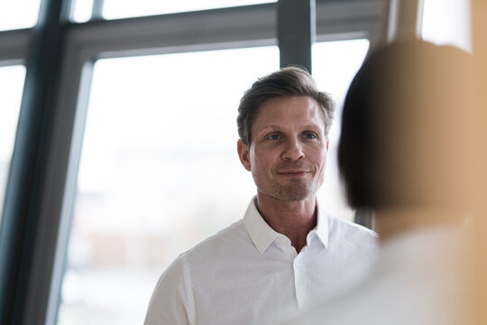 Businessman talking to female colleague