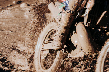 Close-up motocross wheel with water and mud