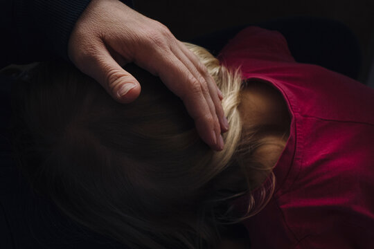 Father stroking son's head, close-up