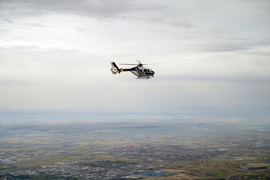 Spain, Madrid, Police helicopter flying above city