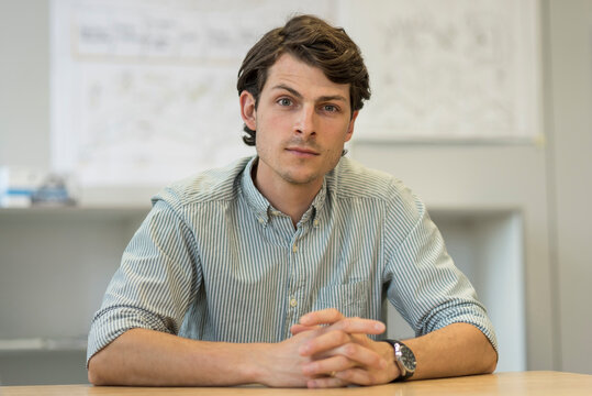 Portrait of businessman sitting at desk in office