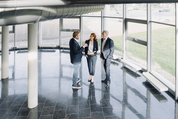 Business people talking at the window in modern office building