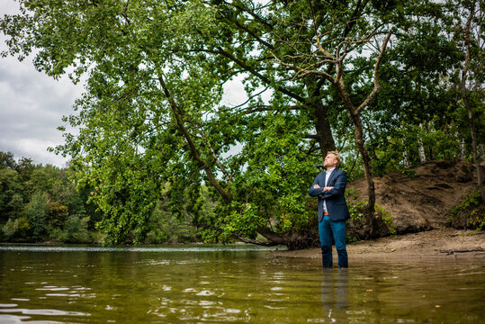 Businessman at a lonely island in a lake
