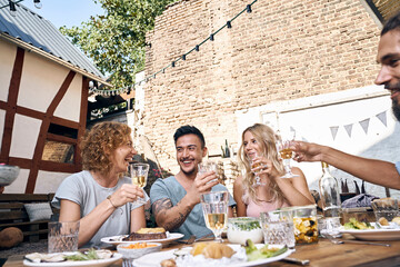 Friends having fun at a barbecue party, eating together