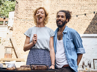 Friends preparing meat for a barbecue in the backyard