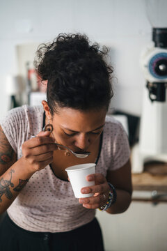 Woman working in a coffee roastery tasting product