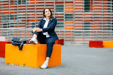 Businesswoman sitting outside office building in the city