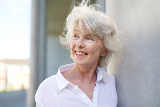 Portrait of happy mature woman with blowing hair