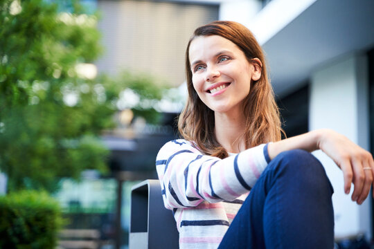 Smiling woman having a break in the city