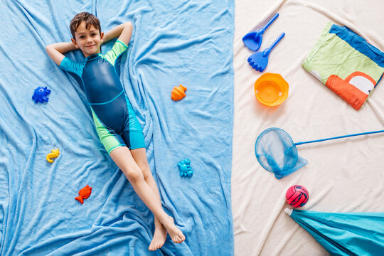 Studio Shot Of Boy Floating In Water At The Beach