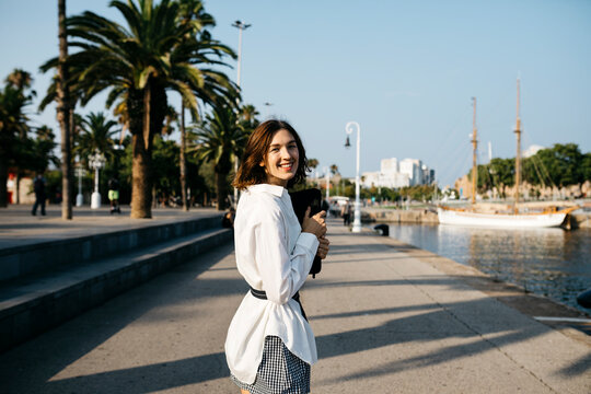 Pretty businesswoman walking in the city after work