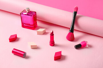 Composition with cosmetics, brush and makeup sponges on color background