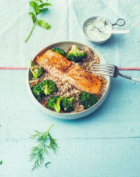 Fried salmon with buckwheat pilaf and broccoli in a bowl