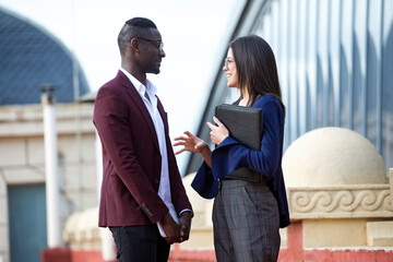 Businessman and woman having a meeting on a hotel terrace