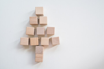 Christmas tree made of woon cubes on white background.