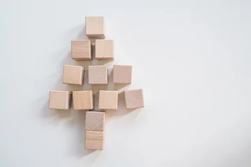 Deurstickers Christmas tree made of woon cubes on white background. © hallojulie