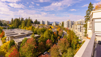 Lovely fall colours on tree-lined University Crescent at Univercity Highlands, Burnaby, BC, with North Shore mountain backdrop.