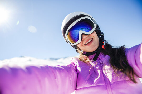 Selfie of happy young woman in ski clothes