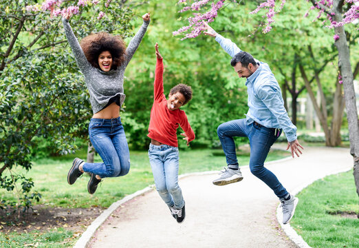 Happy fmily jumping for joy in a park