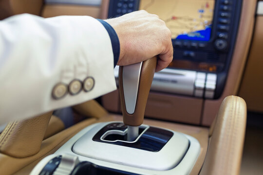 Hand of a businessman on the gearshift