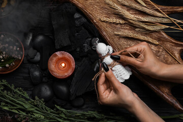 Evil witch performing ritual at table