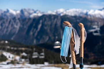 Face mask hanging on ski pole during COVID-19
