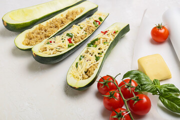 Composition with quinoa stuffed zucchini boats on light background
