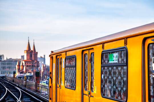 Train on elevated railway in front of Oberbaum Bridge at twilight, Berlin, Germany