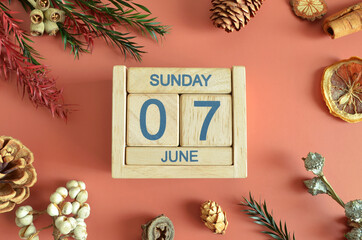 June 7, Cover design with calendar cube, pine cones and dried fruit in the natural concept.