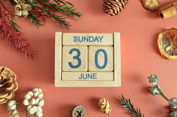 June 30, Cover design with calendar cube, pine cones and dried fruit in the natural concept.