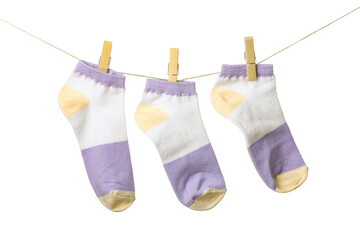 Three socks hanging on rope against white background