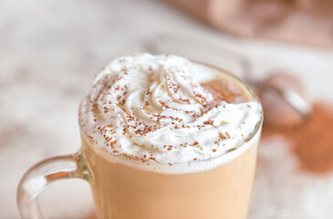 Glass cup of tasty Tiramisu Latte on table, closeup
