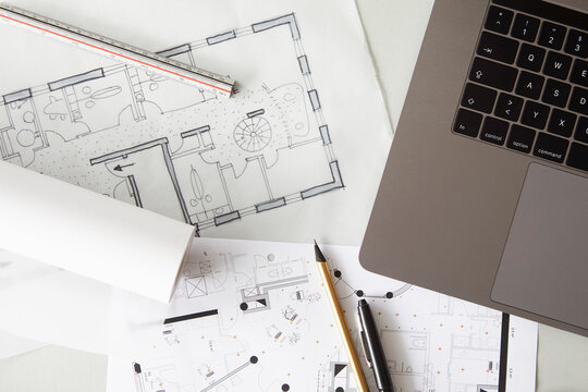 Architectural&Ocirc;&oslash;&Omega;blueprints and edge of laptop