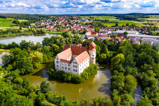 Germany, Bavaria, Moated castle surrounded with trees, aerial view
