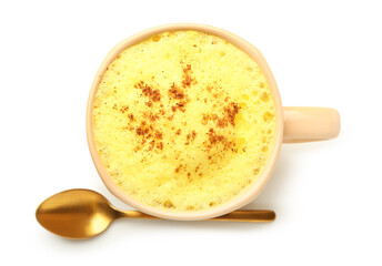 Cup of healthy turmeric latte with spoon on white background