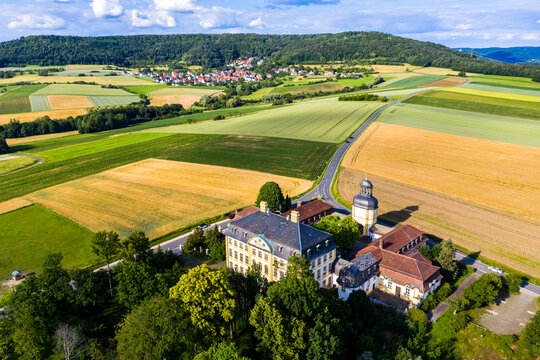 Germany, Bavaria, Eggolsheim, Helicopter view of Schloss Jagersburg and surrounding fields in summer