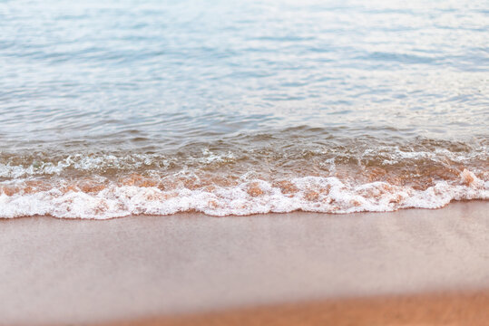 Close-up of water ripples and sandy beach in summer at Skaha Lake, Okanagan Valley