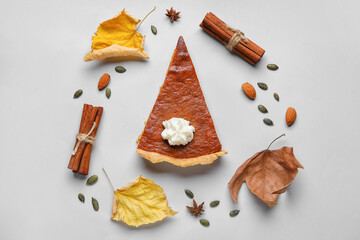 Composition with piece of tasty pumpkin pie on grey background