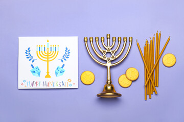 Different symbols of Hanukkah and greeting card on color background