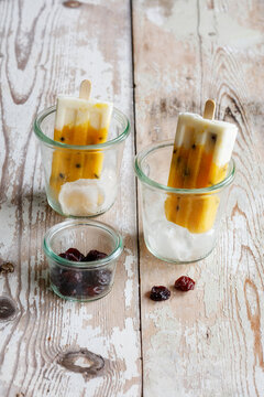 Homemade popsicles with mango and passion fruit